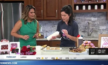 Two women displaying & discussing cooking techniques