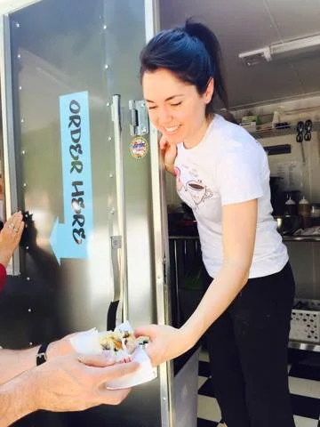 Karissa serving donuts from her vendor truck